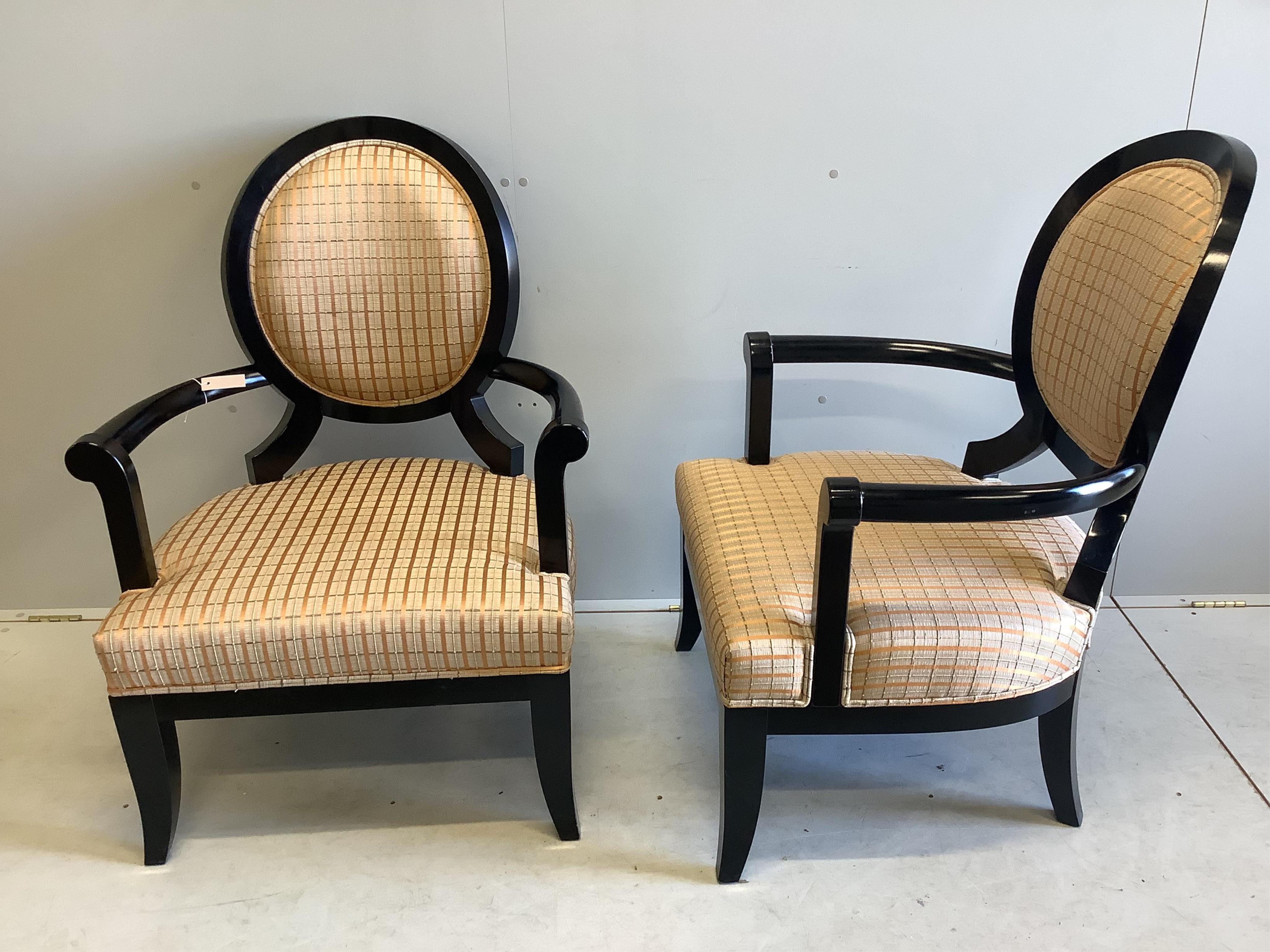 A pair of James Martin ebonised elbow chairs, width 74cm, depth 60cm, height 100cm. Condition - good